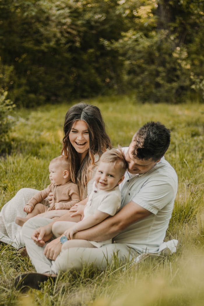 Home Candid family portrait capturing parent-child bonding in a serene outdoor setting.