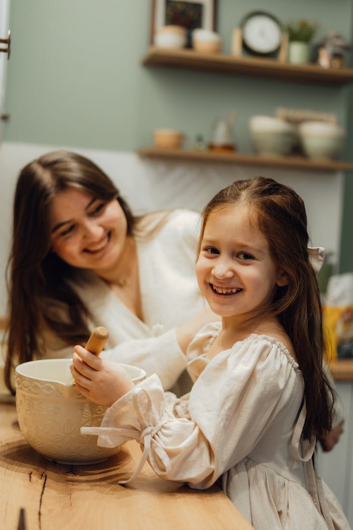 Service A joyful mother and daughter baking in a warm, cozy kitchen setting, sharing special moments.